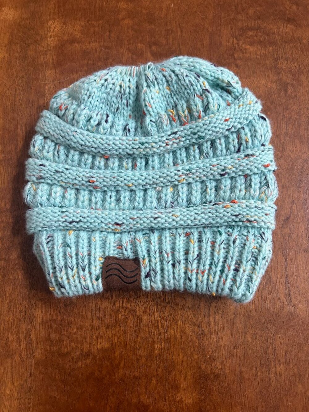 Light blue speckled beanie with hole for hair